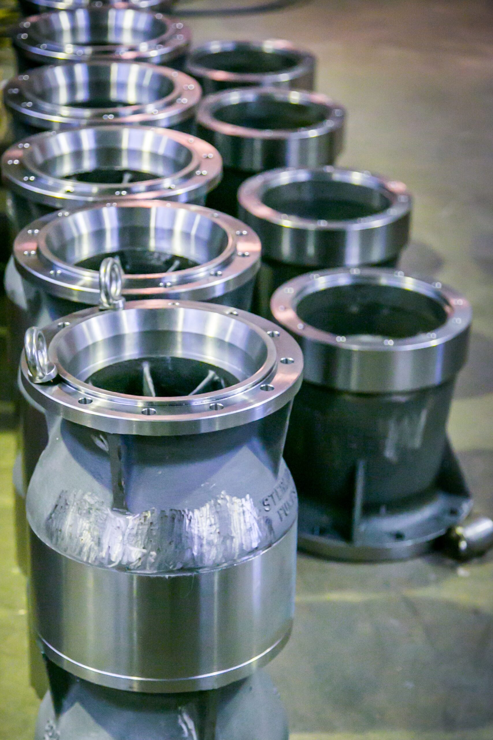 Shiny metal cylinders arranged in sequence