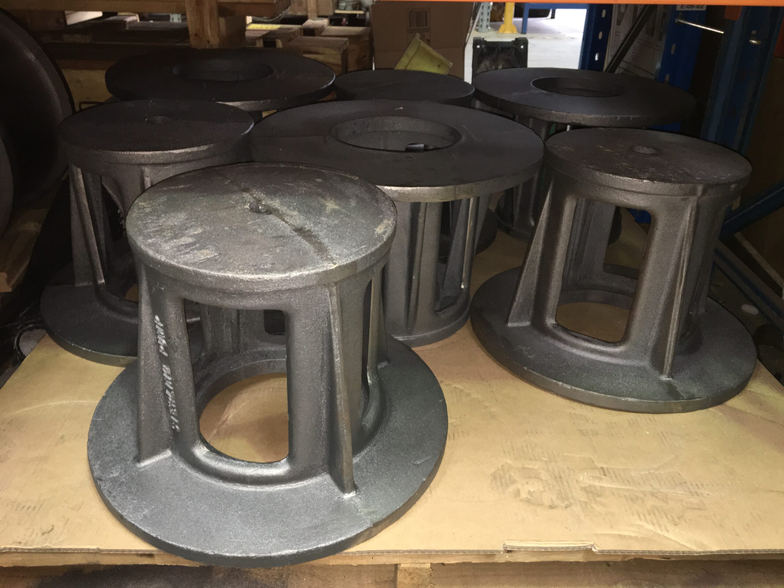 Metal industrial components stacked on shelf